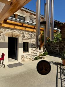 a house with a red chair and a building at Chez Delphine in Doizieux