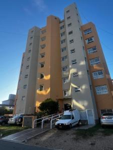 een witte bestelwagen geparkeerd voor een gebouw bij Metro in Villa Gesell
