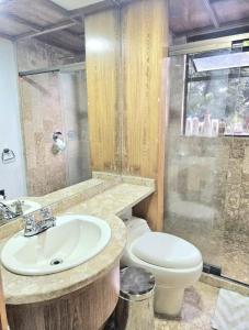 a bathroom with a sink and a toilet at master bedroom in Medellín