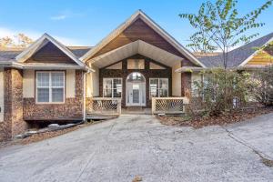 a house with a driveway leading to the front door at The Greenview Manor with Lake Views in Kimberling City