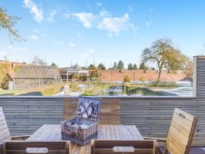 a patio with a wooden table and two chairs at Garden Cottage - Uk45498 in Great Budworth