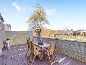 a wooden table and chairs on a wooden deck at Garden Cottage - Uk45498 in Great Budworth