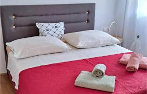 a bedroom with a bed with two towels on it at Nice Apartment In Omis With Wifi in Tice
