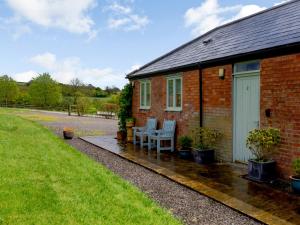 a brick house with a table and chairs on a patio at Primrose in Shepton Mallet +14 photos