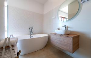 Un baño con bañera, lavabo y espejo. en Nice Home In Brodarica, en Brodarica