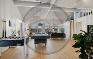 a living room with two pool tables in it at Beautiful Home In Idestrup With Sauna in Stovby