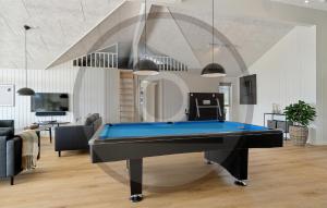 a living room with a pool table in it at Beautiful Home In Idestrup With Sauna in Stovby +17 photos