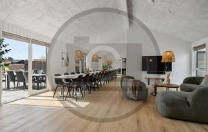 a living room with a dining room table and chairs at Beautiful Home In Idestrup With Sauna in Stovby