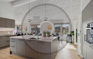 a kitchen with a large island in a room at Beautiful Home In Idestrup With Sauna in Stovby