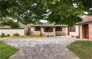 a stone driveway in front of a brick house at Awesome Stacaravan In Obrovac With Wifi in Obrovac