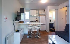 a small kitchen with a counter and stools in a room at Awesome Stacaravan In Obrovac With Wifi in Obrovac