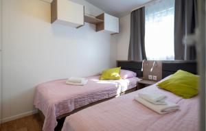 a room with two beds with towels on them at Awesome Stacaravan In Obrovac With Wifi in Obrovac