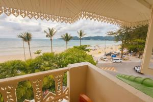 a balcony with a view of a beach and the ocean at The Taksim Royal Beach Hotel in Patong Beach