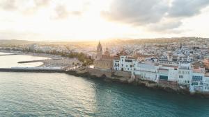 an aerial view of a city next to the water at HolaCamp Sitges Garrofer in Sitges