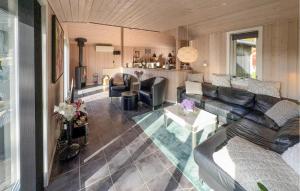 a living room with a couch and a table at Stunning Home In Tarm With Sauna in Højsand