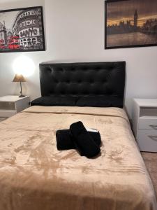 a bedroom with a bed with a black bag on it at Trainer Center House in Tres Arroyos