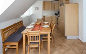 een keuken met een houten tafel met stoelen en een eetkamer bij Awesome Home In Röbel With House A Panoramic View in Marienfelde