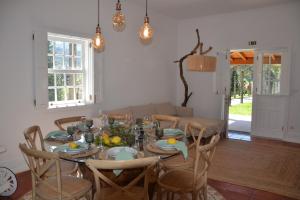 ein Esstisch und Stühle in einem Wohnzimmer in der Unterkunft Quinta de Grejufe - Ponte de Lima in Olheiro + 37 Fotos