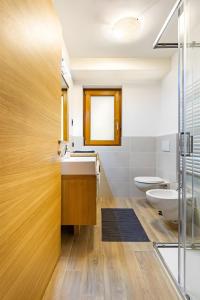 a bathroom with a sink and a toilet at Appartamenti Via Dell'Asilo in Isolaccia +16 photos