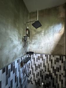 a shower in a bathroom with a black and white at David's Hostel & Restaurant in Koh Rong +35 photos