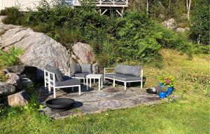 a patio with two chairs and a fire pit at Cozy Home In Førde I Hordaland in Erve