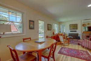 a living room with a wooden table and a dining room at Living Color Cottage in Hood River