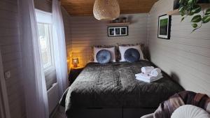キルナにあるAurora River Camp Glass igloos & cabinsのベッドとタオル2枚のある寝室