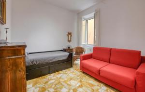 a living room with a red couch and a bed at 2 Bedroom Gorgeous Apartment In Rapallo in San Michele di Pagana