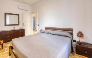 a bedroom with a bed and a dresser and a mirror at 2 Bedroom Gorgeous Apartment In Rapallo in San Michele di Pagana