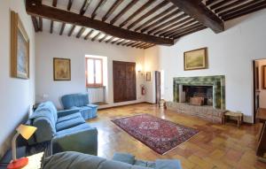 a living room with a blue couch and a fireplace at Casa Dei Lecci in Colle San Lorenzo
