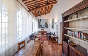 a living room with a wooden table and a large window at Casa Dei Lecci in Colle San Lorenzo