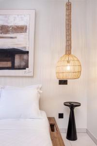 een slaapkamer met een bed, een lamp en een tafel bij Appartement de charme-Luxe, douceur et harmonie in Lyon