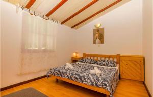 a bedroom with a bed in a room with a window at Beautiful Apartment In Ivan Dolac With Wifi in Ivan Dolac