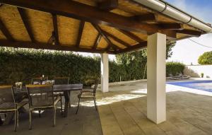 a patio with a table and chairs under a wooden pergola at Amazing Home In Polaca in Pertenjača +25 photos
