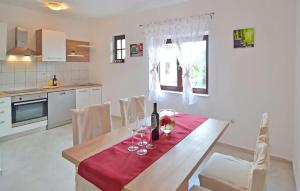 a kitchen with a table with wine glasses on it at Amazing Home In Polaca in Pertenjača