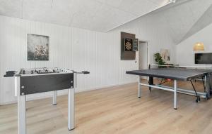 a ping pong table in a room with a ping pong ball at Amazing Home In Glesborg With Sauna in Fjellerup +32 photos