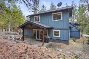 a blue house in the woods at Trails End Retreat in Bend