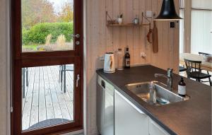 a kitchen with a sink and a view of a patio at Beautiful Home In Gilleleje With Wifi in Gilleleje