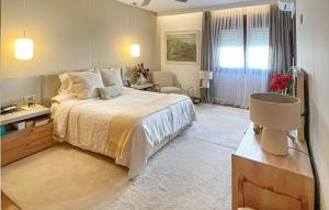 a bedroom with a large bed and a desk at Amazing Home In Rincón De La Victoria in Rincón de la Victoria