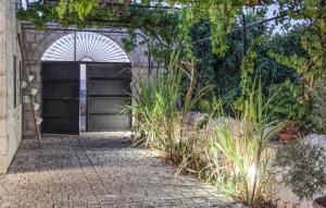 a building with a gate and a brick walkway at Lovely Home In Modica in Modica