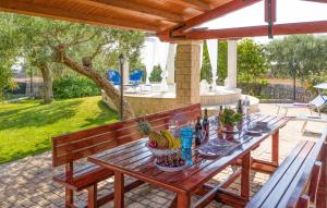 a wooden table with fruit on it on a patio at Lovely Home In Modica in Modica