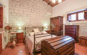 a bedroom with a bed and a wooden dresser at Lovely Home In Modica in Modica