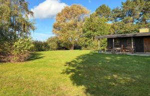 a cabin in a field with a large yard at 2 Bedroom Stunning Home In Helsinge in Karsemose +3 photos