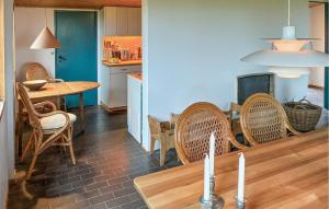 a kitchen and dining room with a table and chairs at 2 Bedroom Stunning Home In Helsinge in Karsemose