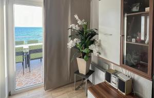 ein Wohnzimmer mit einer Vase mit Blumen auf einem Tisch in der Unterkunft 2 Bedroom Stunning Apartment In Podstrana in Podstrana