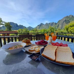a table with sandwiches and other food on it at Sichaluenkham vangvieng HOTEL in Vang Vieng