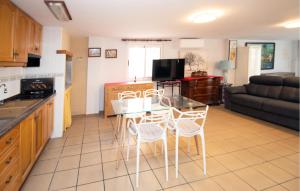 a kitchen and living room with a table and chairs at Beautiful Apartment In Oliva With Wifi in Playa Oliva Nova