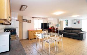 a kitchen and living room with a table and chairs at Beautiful Apartment In Oliva With Wifi in Playa Oliva Nova