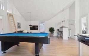 a living room with a pool table in it at Cozy Home In Glesborg With Sauna in Fjellerup +19 photos