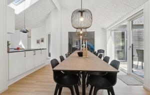 a kitchen and dining room with a table and chairs at Cozy Home In Glesborg With Sauna in Fjellerup